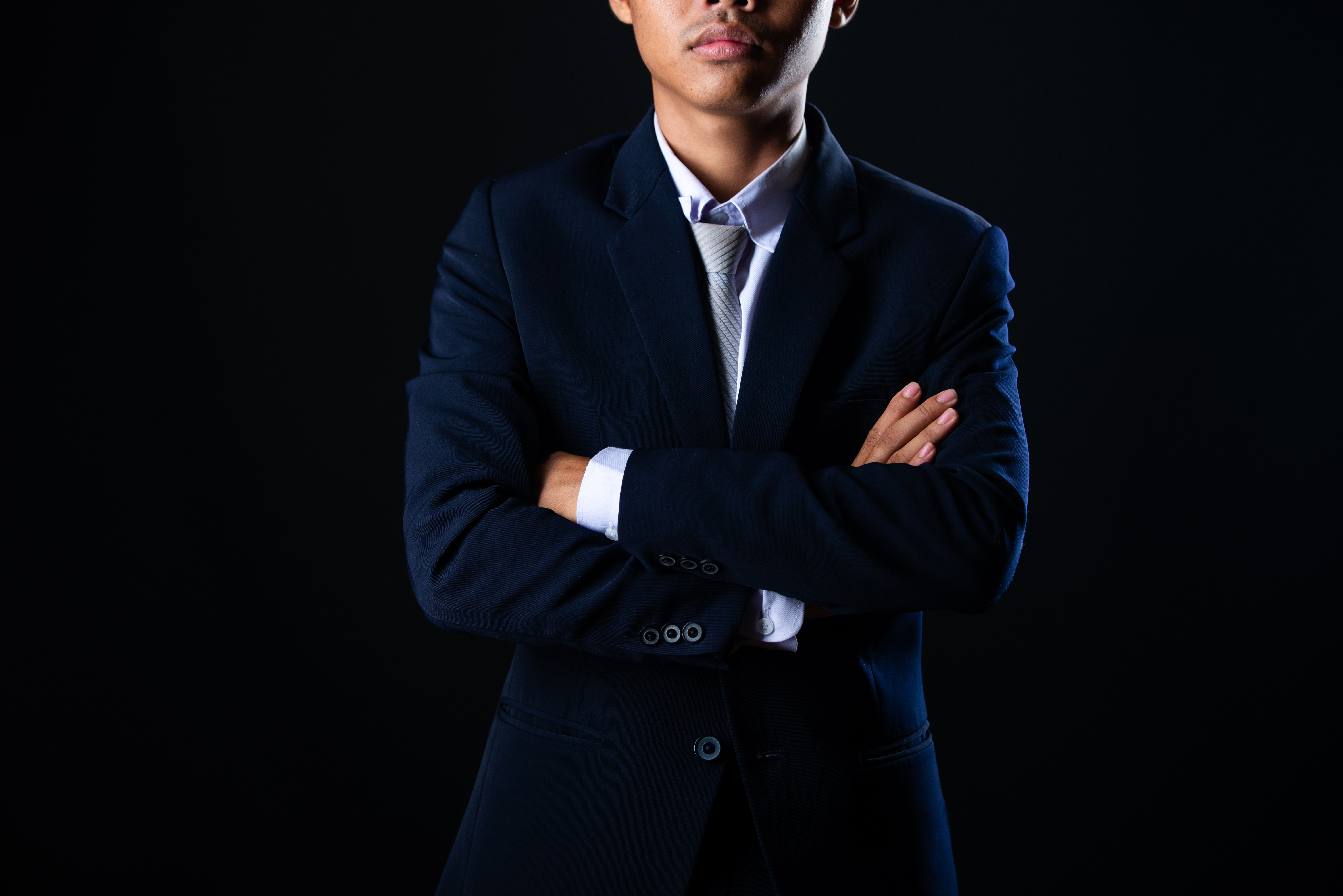 Professional in navy suit representing discretion and confidentiality